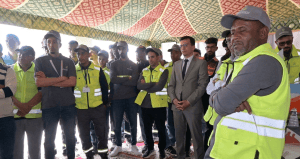 Gemini_Generated_Image_4y0ty94y0ty94y0t | MCG24 | موقع إلكتروني مغربي شامل متجدد على مدار الساعة Group of workers in high-visibility vests standing under a patterned tent, listening to a speaker or briefing the crowd beneath,
