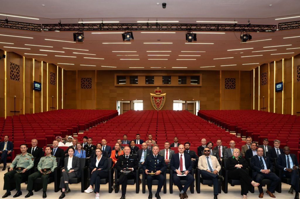 WhatsApp Image 2026-05-20 at 180946 | MCG24 | موقع إلكتروني مغربي شامل متجدد على مدار الساعة Group of formally dressed officials seated in a large auditorium with red seats and a crest on the back wall behind them, posing for a photo.