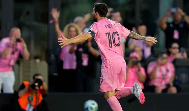 ميسي-1024x601 | MCG24 | موقع إلكتروني مغربي شامل متجدد على مدار الساعة Soccer player in a pink uniform with number 10 celebrates with arms outstretched on the field as fans cheer in the background.