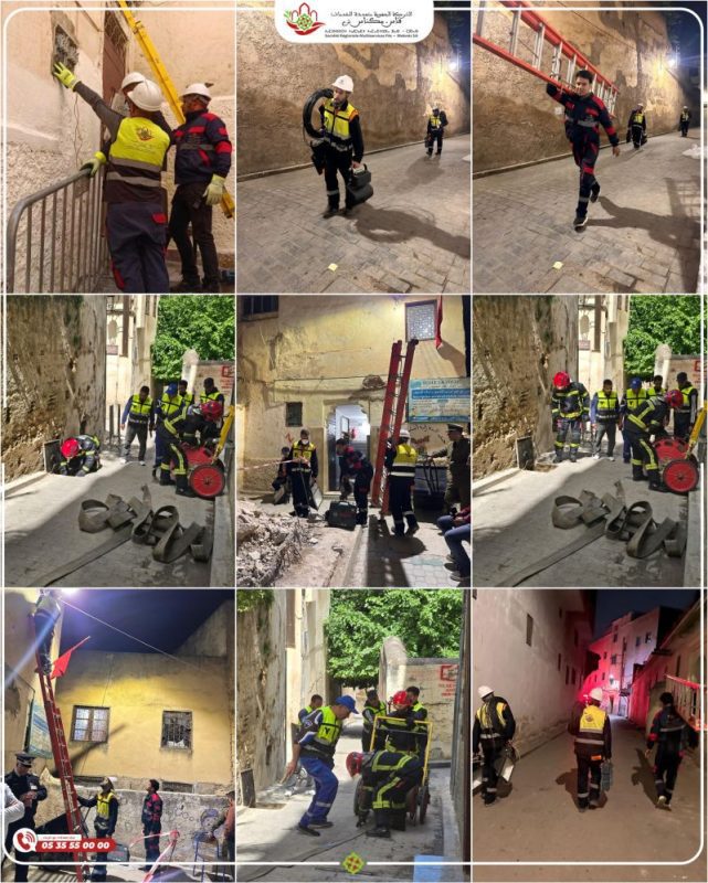 1777977892612 | MCG24 | موقع إلكتروني مغربي شامل متجدد على مدار الساعة Firefighters in reflective gear repair a wall with a yellow ladder in a narrow street.