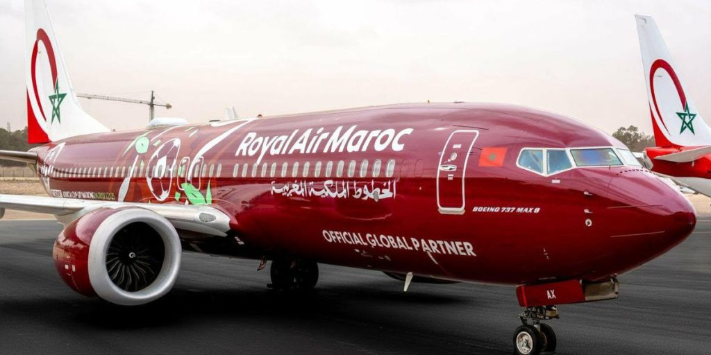 laram | MCG24 | موقع إلكتروني مغربي شامل متجدد على مدار الساعة Royal Air Maroc Boeing 737 MAX 8 on the tarmac with Moroccan flag livery and 'Official Global Partner' text on the fuselage