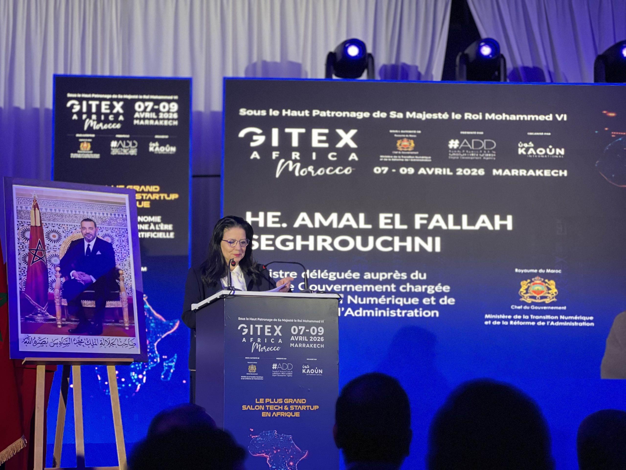 Female speaker at a podium during the SITEX Africa Morocco conference, with blue banners showing 07-09 Avril 2026 Marrakech.