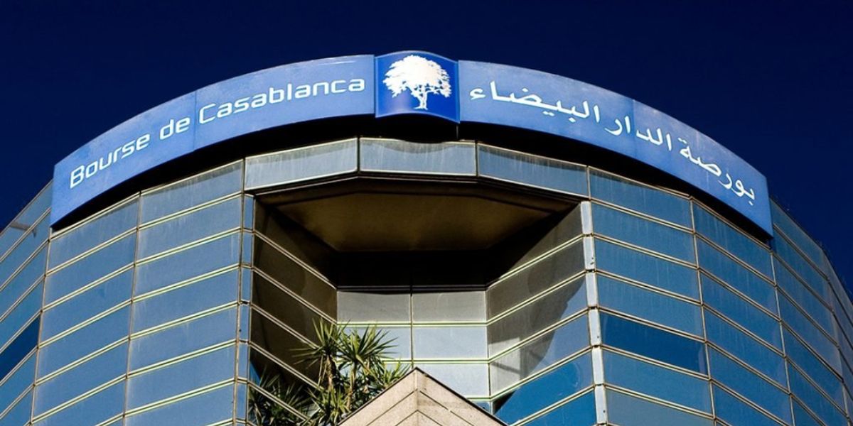 Facade of the Casablanca Stock Exchange building with a curved blue sign reading 'Bourse de Casablanca' in French and Arabic.