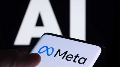 Smartphone showing the Meta logo with large AI letters in the blurred background.