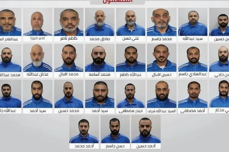 Group photo showing many men in blue uniforms arranged in rows, each portrait labeled with Arabic captions (no names read).