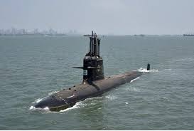 Submarine afloat on calm sea with its conning tower visible above the water surface