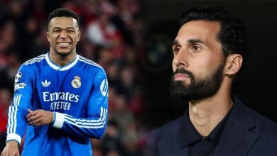 Two men side by side: left is a Real Madrid footballer in a blue kit smiling, right is a bearded man in a dark suit looking away.