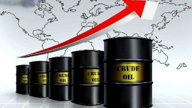 Series of black crude oil barrels with a red upward arrow and world map background, indicating rising oil prices or demand.