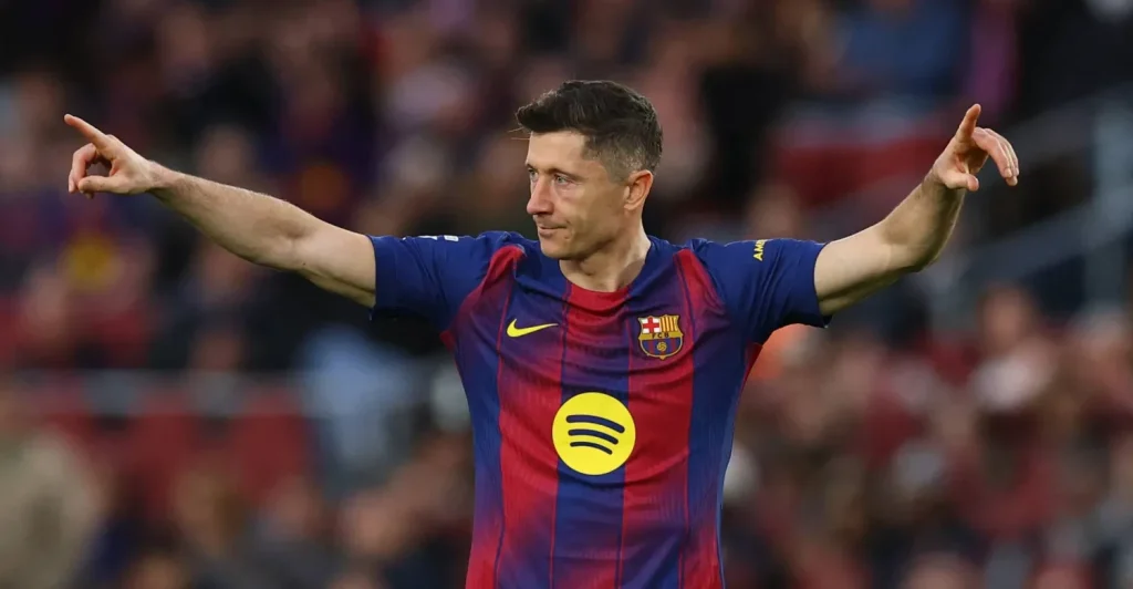 1778934826222 | MCG24 | موقع إلكتروني مغربي شامل متجدد على مدار الساعة FC Barcelona player in blue-red home kit celebrating on the pitch with arms outstretched and Spotify logo visible on the chest.