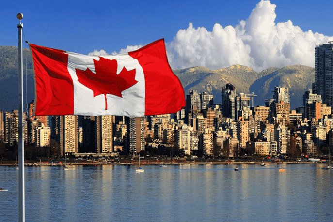 5fbfb9887053a | MCG24 | موقع إلكتروني مغربي شامل متجدد على مدار الساعة Canadian flag waving on a pole with a city skyline and water in the background.