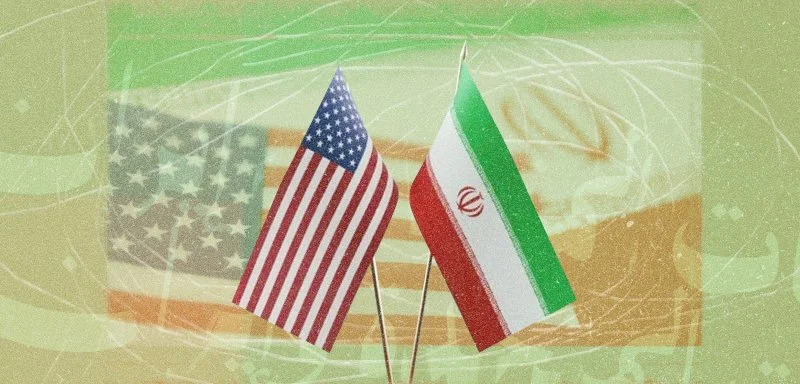 666709 | MCG24 | موقع إلكتروني مغربي شامل متجدد على مدار الساعة Two small national flags, United States and Iran, planted upright on a green abstract background.