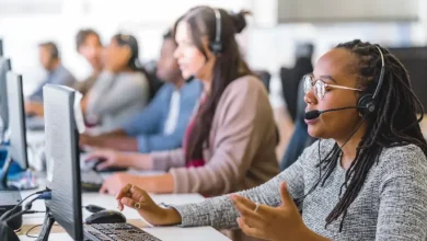 673f033c6e7a6b29508956b3_Call Center Maroc | MCG24 | موقع إلكتروني مغربي شامل متجدد على مدار الساعة Customer service agent with headset at a computer in a busy call center environment.