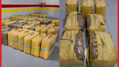 Many yellow-wrapped rectangular packages tied with strings on a ship deck.