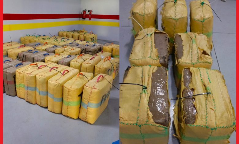 Many yellow-wrapped rectangular packages tied with strings on a ship deck.