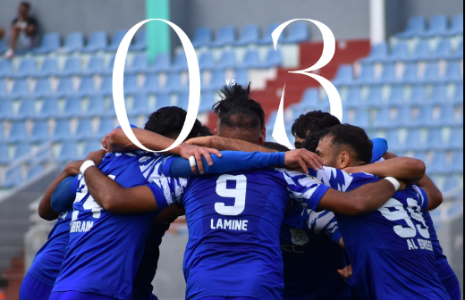 Soccer players in blue jerseys form a tight huddle on the field, backs visible with number 9 Lamine.