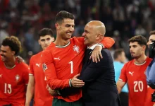 GettyImages-2219217456jpg | MCG24 | موقع إلكتروني مغربي شامل متجدد على مدار الساعة Portugal national team players celebrate on the field, embracing a teammate in red jerseys with numbers visible (7 and 20).