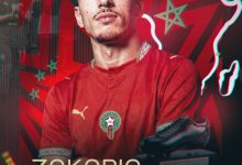 Portrait of Zakaria El Ouahdi in a red jersey, with a neon-outline map of Morocco and award graphics in the background for the Soulier d'Ebene African Awards