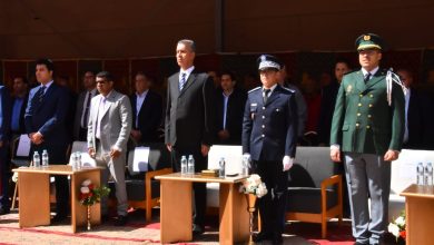 IMG-20260516-WA0017 | MCG24 | موقع إلكتروني مغربي شامل متجدد على مدار الساعة Group of formally dressed officials and uniformed officers standing at a ceremony, with tables and water bottles in front of them