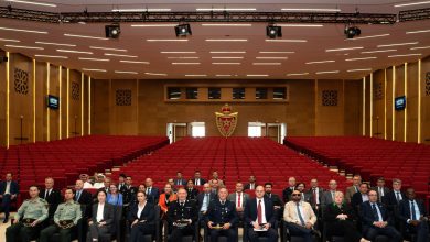 WhatsApp Image 2026-05-20 at 180946 | MCG24 | موقع إلكتروني مغربي شامل متجدد على مدار الساعة Group of formally dressed officials seated in a large auditorium with red seats and a crest on the back wall behind them, posing for a photo.