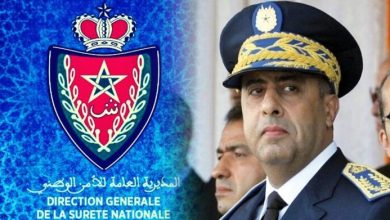 Emblem of the Direction Générale de la Sûreté Nationale beside a stern police general in uniform.