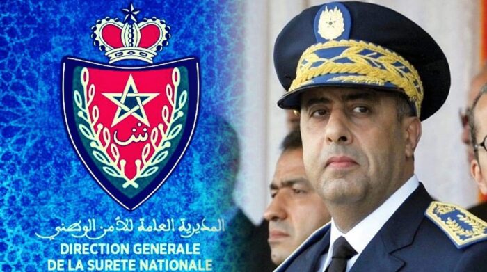 Emblem of the Direction Générale de la Sûreté Nationale beside a stern police general in uniform.
