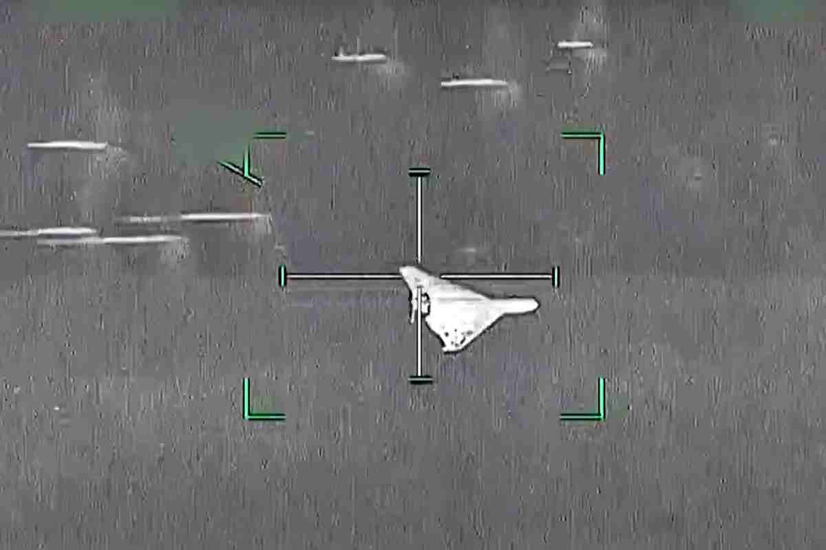 Targeting reticle centered on a pale irregular shape; green corner marks indicate the aim point against a gray background.