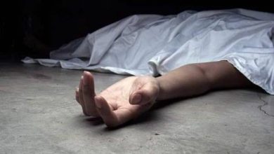 image1024 | MCG24 | موقع إلكتروني مغربي شامل متجدد على مدار الساعة Arm protrudes from under a white sheet on a concrete floor, suggesting a person lying there (potentially unconscious or deceased).