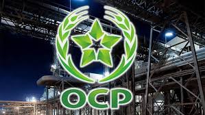 OCP logo: green laurel circle with a star in the center and the letters OCP underneath on a dark, industrial backdrop.