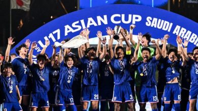 qna_japan_22_5_2026 | MCG24 | موقع إلكتروني مغربي شامل متجدد على مدار الساعة U17 Asian Cup winners, a blue-clad youth soccer team celebrate with trophy and medals.