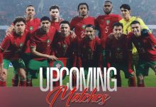 Morocco national football team in red jerseys posing for a group photo on the field, with 'Upcoming Matches' text overlaid.