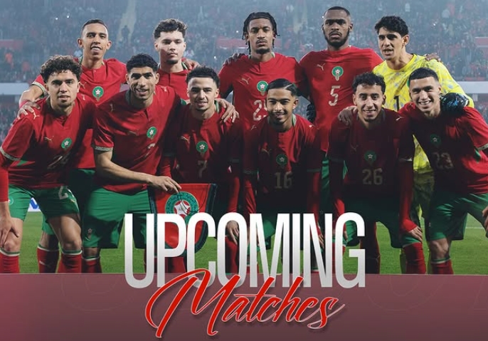 Morocco national football team in red jerseys posing for a group photo on the field, with 'Upcoming Matches' text overlaid.