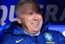 Smiling older man in a blue Brazil national team jacket, crest visible on the chest.
