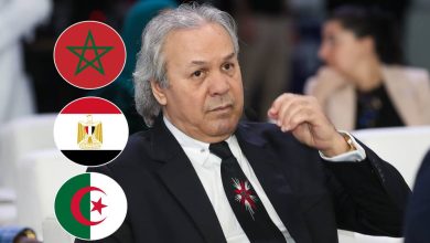6a2ab0d3eefcb11ae1b83c1d_default | MCG24 | موقع إلكتروني مغربي شامل متجدد على مدار الساعة Man in a dark suit at a conference, with three circular flags to his left: Morocco, Egypt, and Algeria.