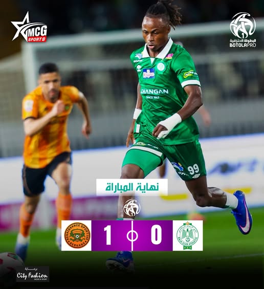 Soccer player in a green kit dribbles the ball during a match; final score 1–0.