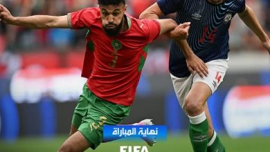 Soccer players clash for the ball on a field; UAE and Morocco flags shown, score UAE 0–Morocco 4, with 'End of match' text in Arabic and FIFA/MCG logos.