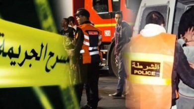 FB_IMG_1781474494793 | MCG24 | موقع إلكتروني مغربي شامل متجدد على مدار الساعة Emergency scene with police and responders behind yellow caution tape with Arabic writing; a police vest is visible in the foreground.