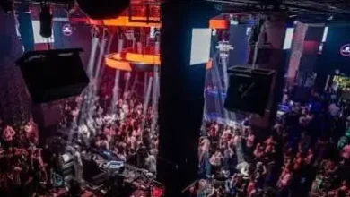 IMG-20260614-WA0100 | MCG24 | موقع إلكتروني مغربي شامل متجدد على مدار الساعة Bird's-eye view of a crowded nightclub with a stage, dancing crowd, and red/orange stage lighting.