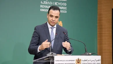 baitas-5 | MCG24 | موقع إلكتروني مغربي شامل متجدد على مدار الساعة Government spokesperson in a dark suit speaking at a lectern with the Moroccan crest and signage behind him.