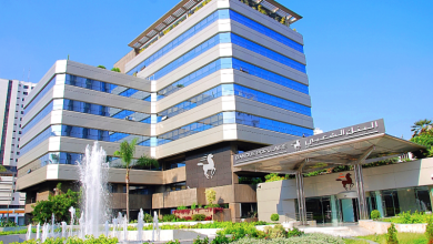 Modern multi-story bank building with a fountain in the foreground and a Banque Populaire sign.