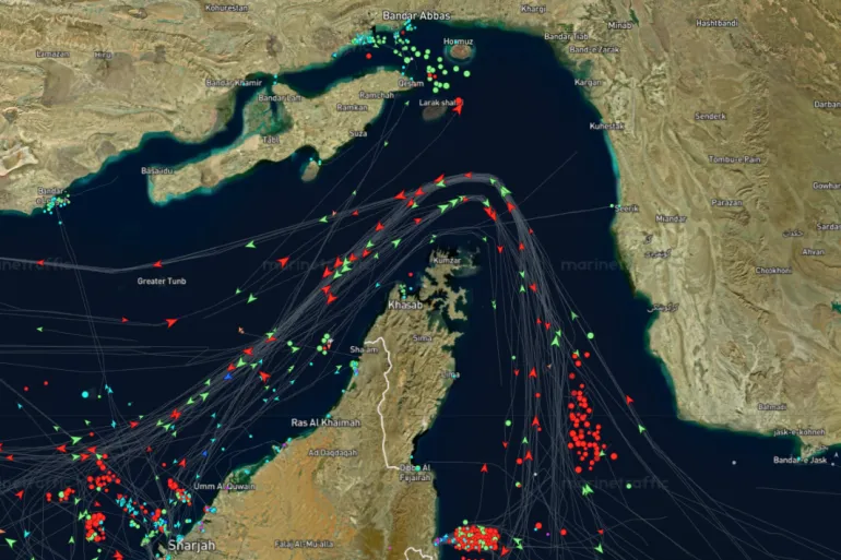 Satellite map of the Persian Gulf showing dense shipping routes with numerous lines and red and green markers around Kuwait, Iran, Bahrain, and the UAE. It indicates heavy maritime traffic in the area while routes curve around islands.