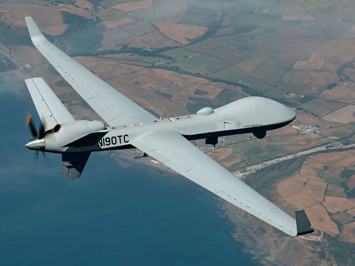 drones-marruecos | MCG24 | موقع إلكتروني مغربي شامل متجدد على مدار الساعة Large white unmanned aircraft with a rear propeller, labeled Experimental, flying over patchwork farmland and coastline.