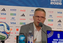 ouahbi-2 | MCG24 | موقع إلكتروني مغربي شامل متجدد على مدار الساعة Man in a suit and glasses speaks into a microphone at a press conference with a World Cup 2026 backdrop and sponsor logos behind him.