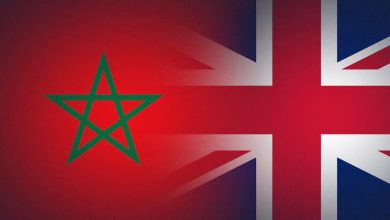 Morocco flag emblem (green pentagram) on a red background with parts of the UK Union Jack showing behind it, suggesting a Morocco-UK connection, collaboration, or overlap.