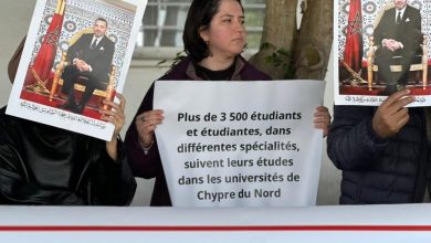 Protesters hold signs, including a large French poster about 3,500 students studying in Northern Cyprus universities.